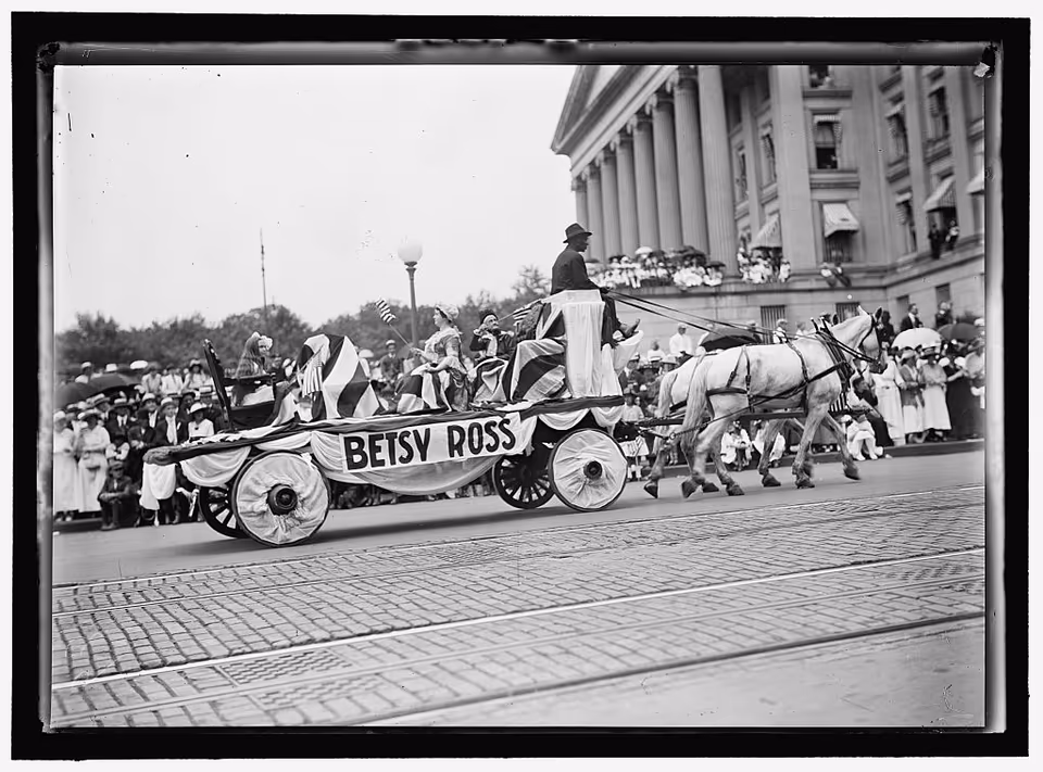 A horse-drawn Betsy Ross float passing crowds during a Fourth of July parade in Washington, D.C., in 1916