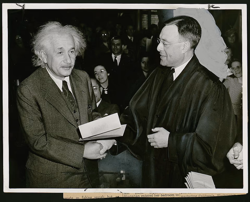 Albert Einstein receiving his United States citizenship certificate from Judge Phillip Forman in 1940